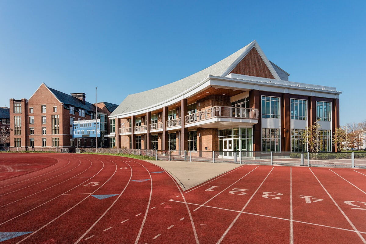 Photo of the outside of Wyant Athletic and Wellness Center with an outdoor running track in the foreground.