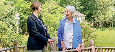 Case Western Reserve University Interim Provost Joy K. Ward talking outdoors with alumna and donor Sara Moll.