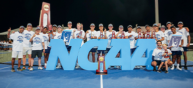 The Case Western Reserve University's men's tennis team lined up behind a giant NCAA sign after winning the NCAA Division III championship.