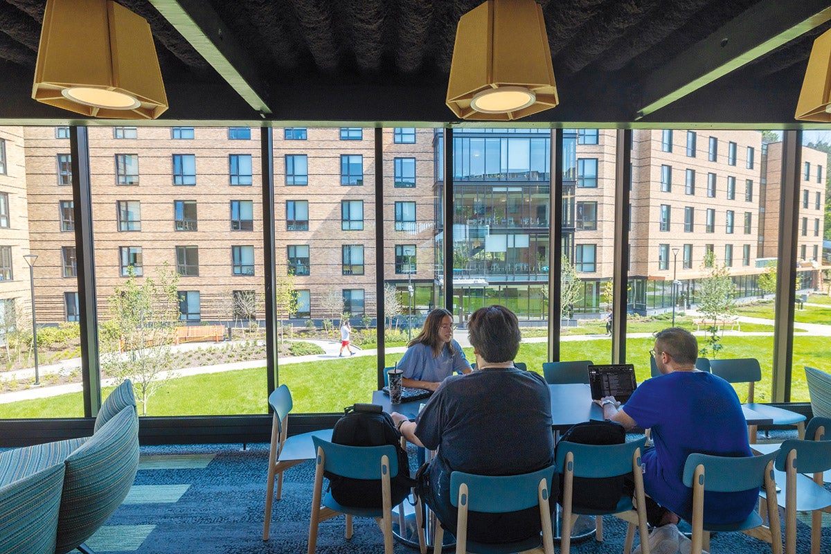 Photo of a student in a residence hall walking up a set of stairs