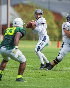 Photo of Case Western Reserve football quarterback Rob Cuda preparing to throw