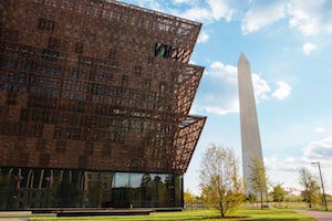 The exterior of the Smithsonian’s National Museum of African American History and Culture, with the Washington Monument in the background