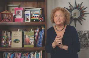 A photo of Case Western Reserve University's Jacqueline Nanfito next to a bookshelf