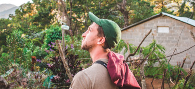 Student Michael Douglass wearing a green ball cap and looking toward the sky in the Dominican Republic