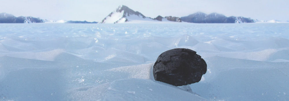 Meteorite sitting in the middle of an icy, Antarctic landscape