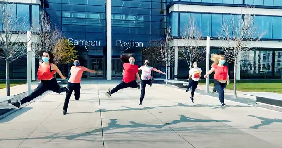 Image of a group of people wearing masks while jumping 