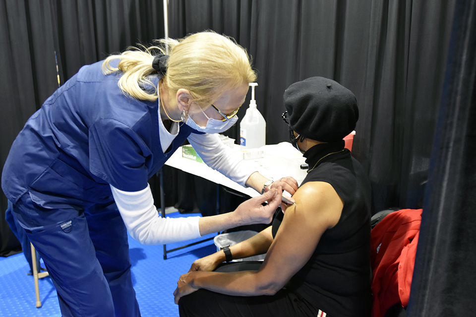 Nurse administering a vaccine to a patient