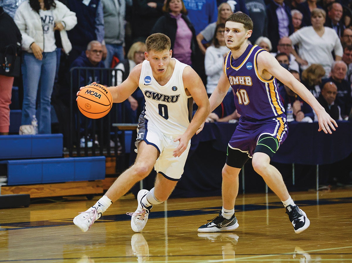 Two students in action during a collegiate basketball game.