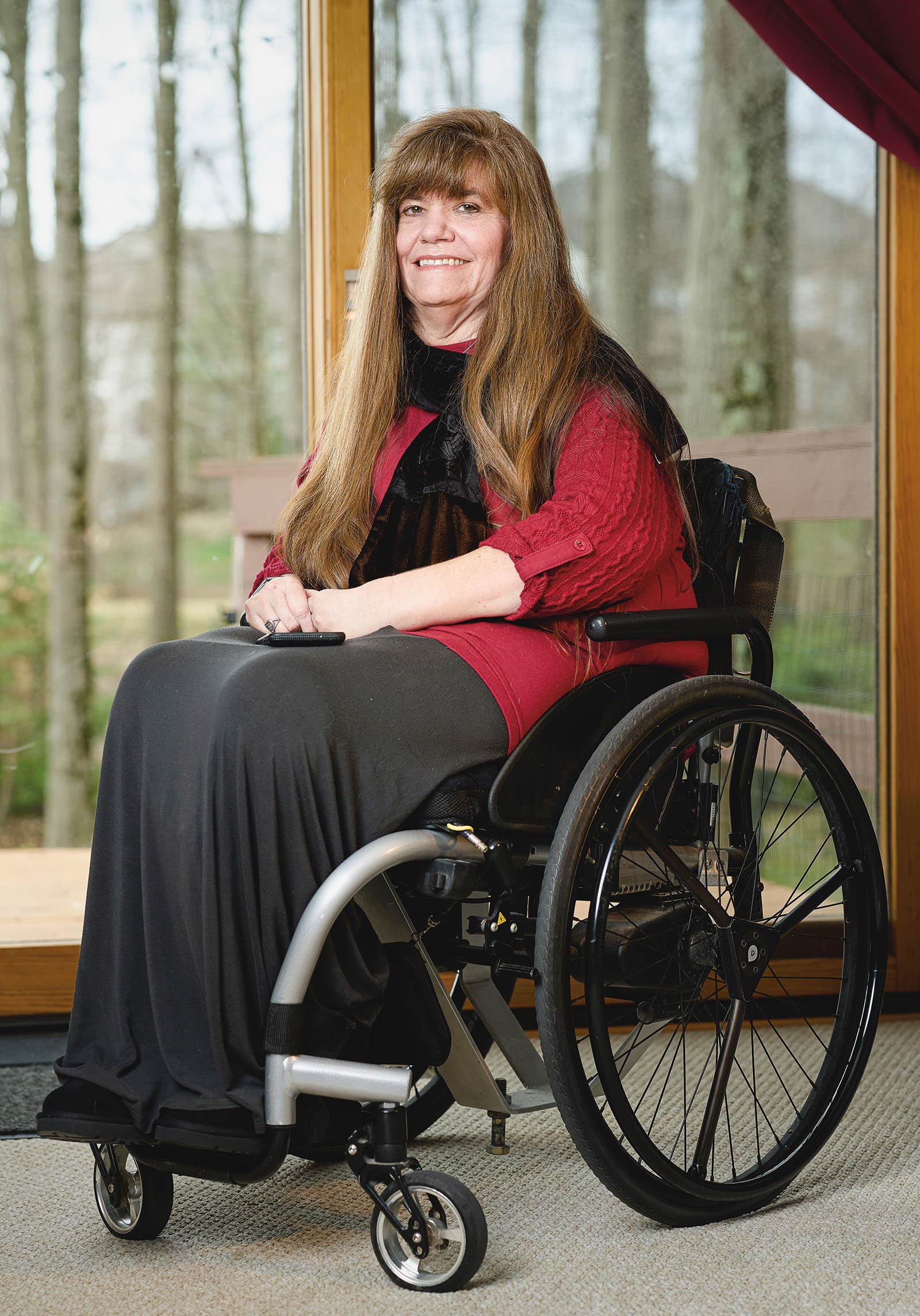 Kim Anderson seated near a sliding-glass door.