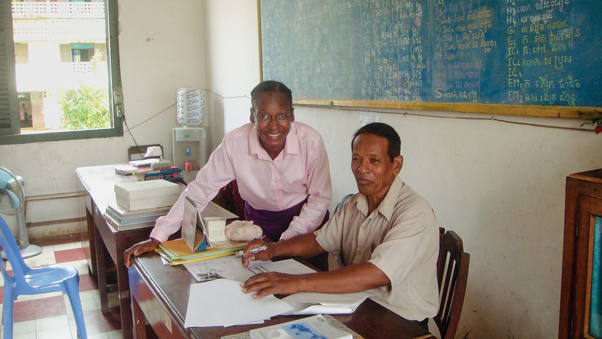 Darlene Grant with a school administrator at a teacher training center in Cambodia.