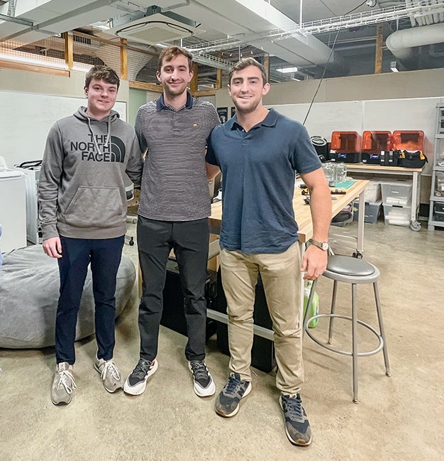 The three founders of CLEANR standing in their office at Case Western Reserve University.