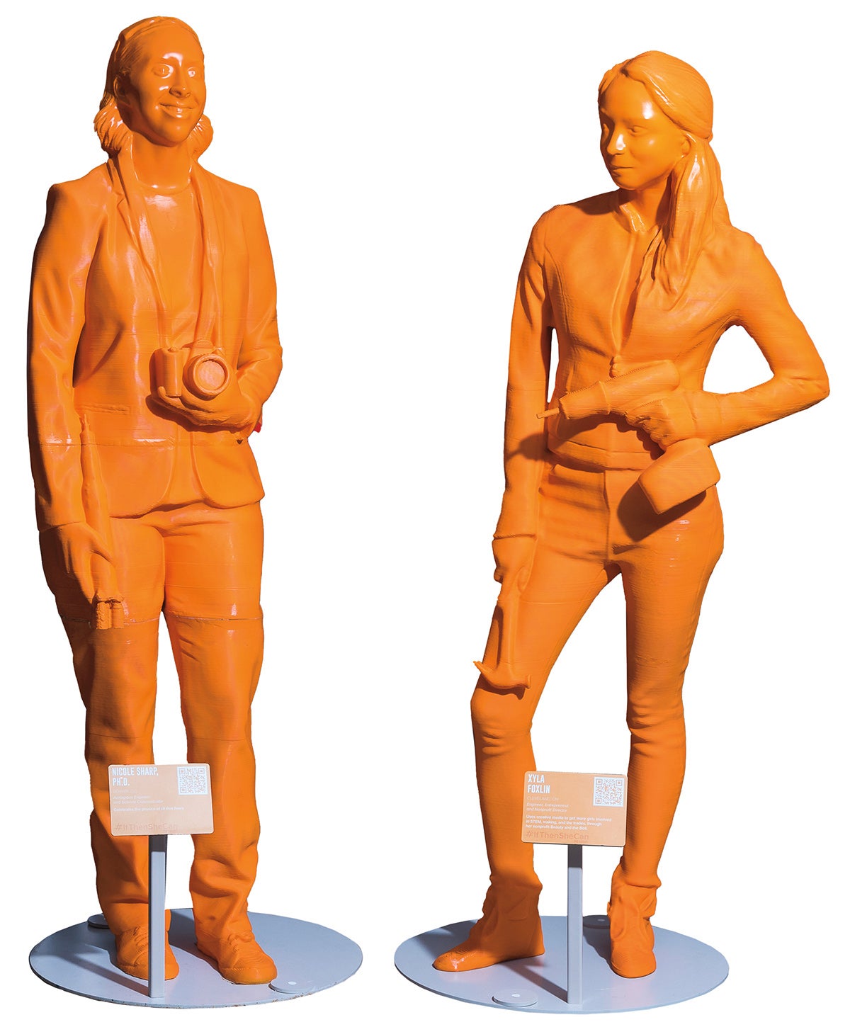 Orange, 3D-printed, life-sized statues of two graduates of Case Western Reserve