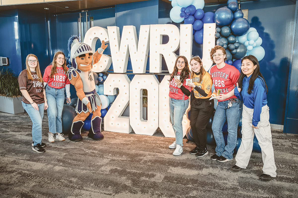 Five students and the Case Western Reserve Spartie mascot flank large letters and numbers that say CWRU 200 to mark the start of the university's bicentennial celebration.