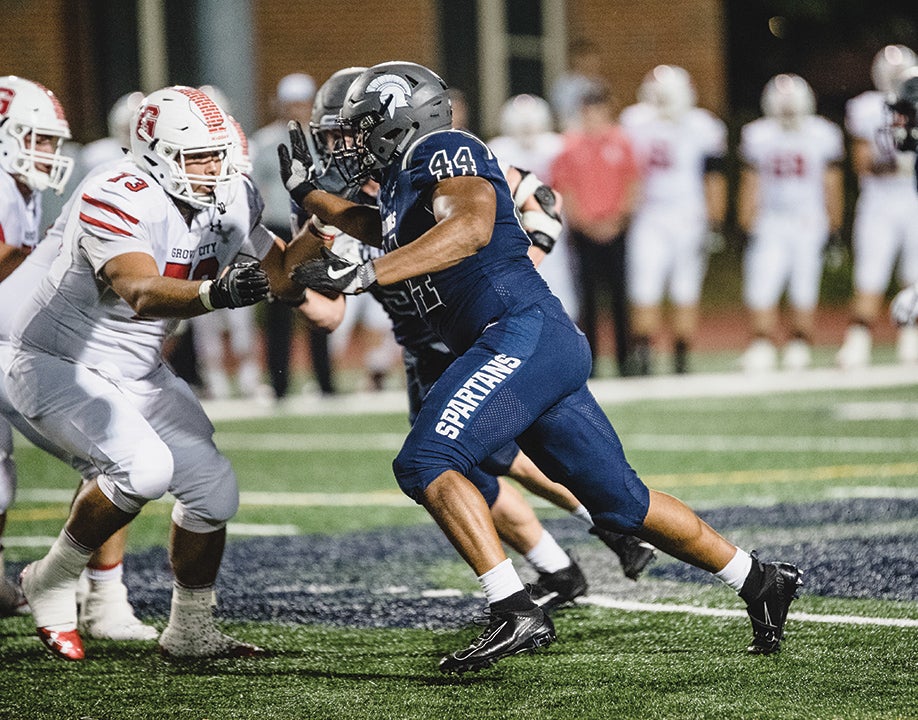 Image depicts college football players, including Cameron Brown, in a football game