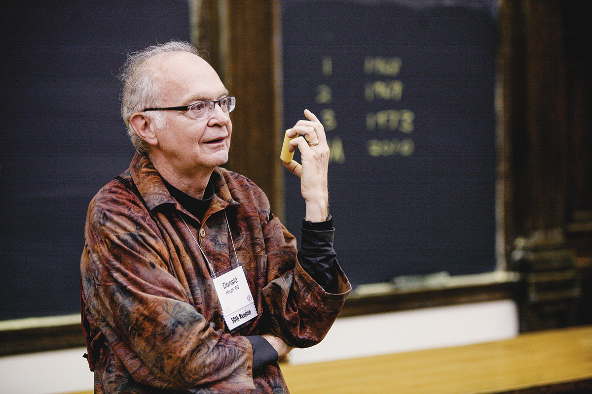 Donald Knuth talking in front of a blackboard