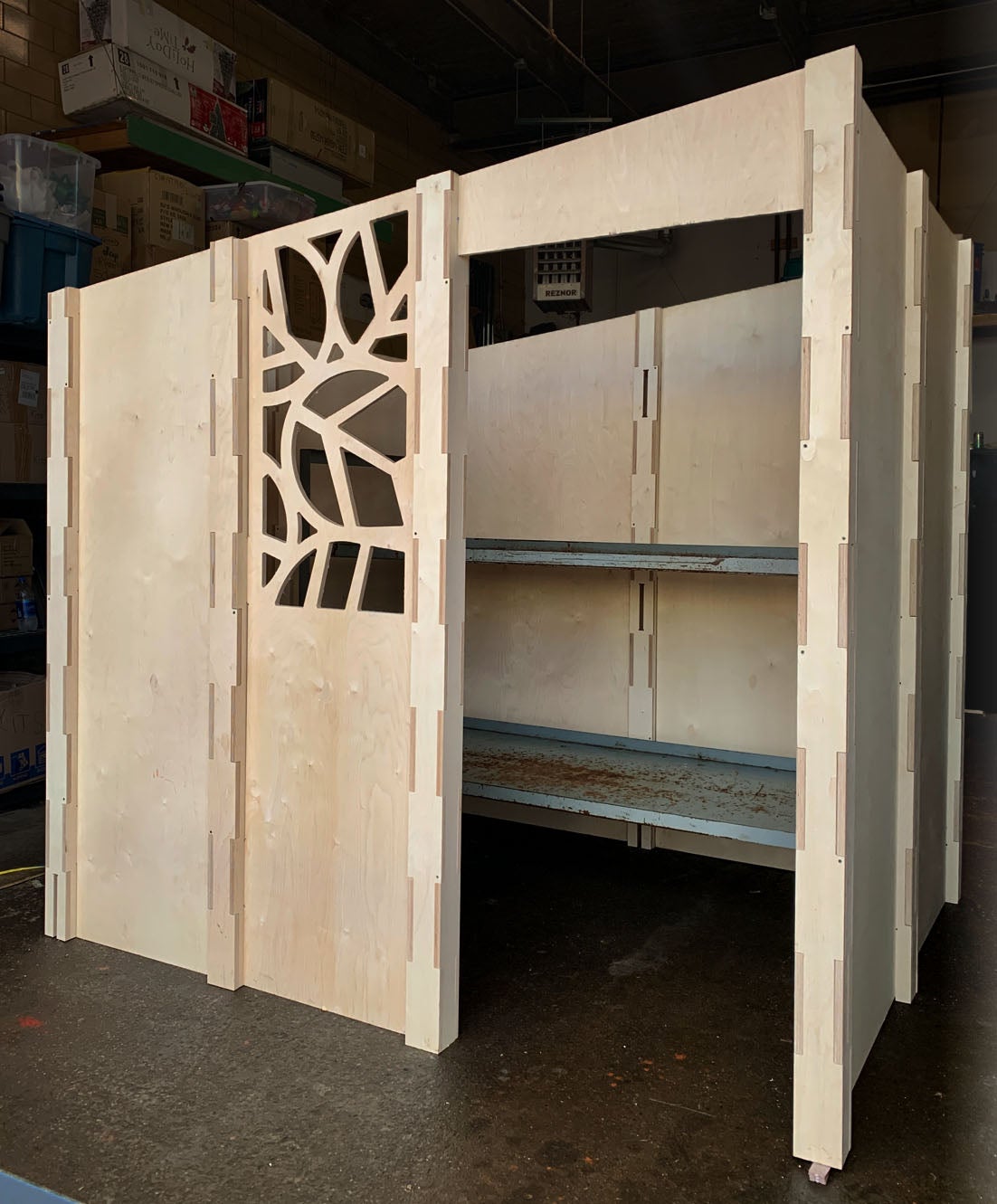 A wooden pod with a door, window, and space for a cot.