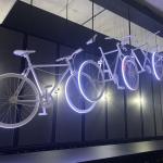A series of ghost bikes with leds rising and falling apart in an art installation.