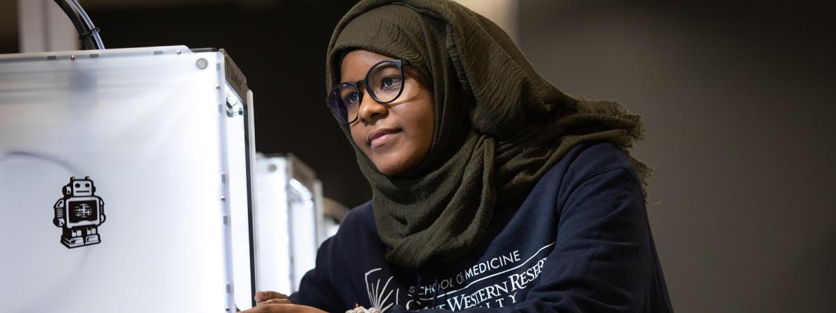 Student working on a 3D printer
