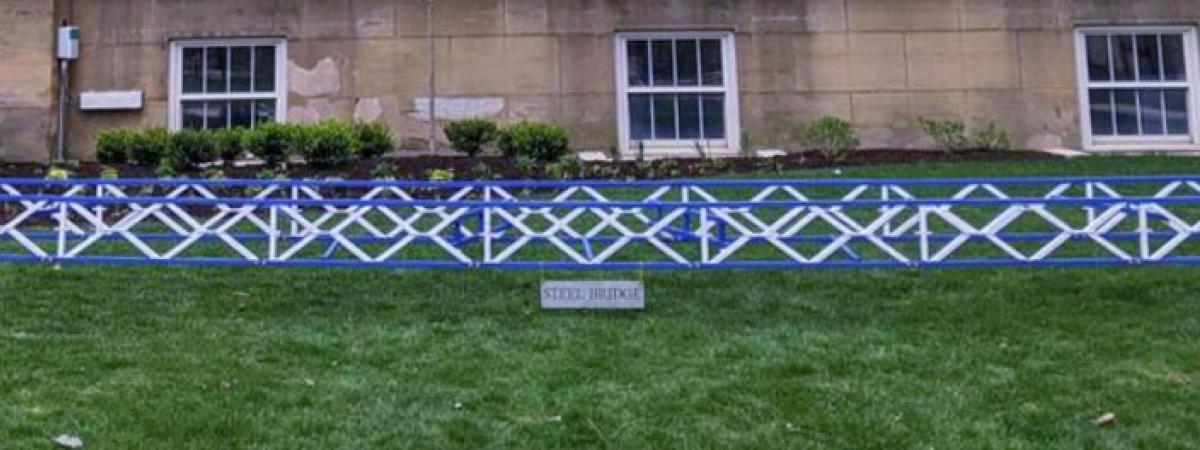 The steel bridge structure on the lawn outside of Bingham