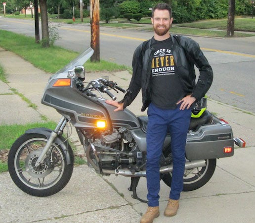 Man standing next to motorcycle