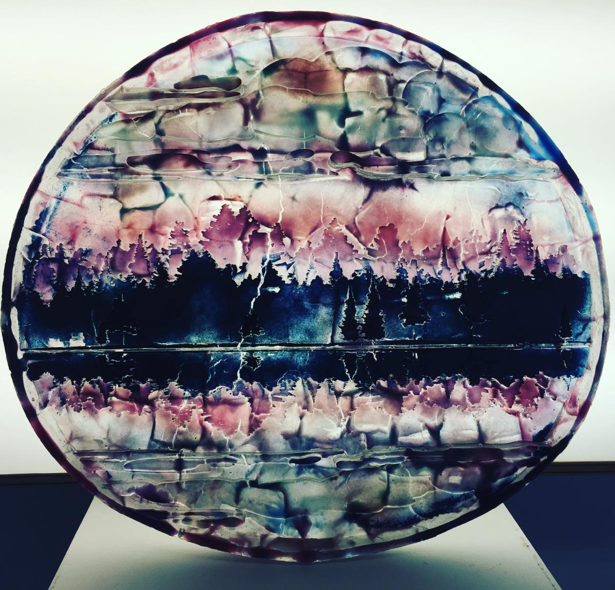 An artwork made of glass that's pink and blue