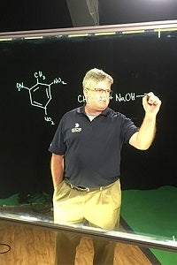Man drawing molecules on the light board