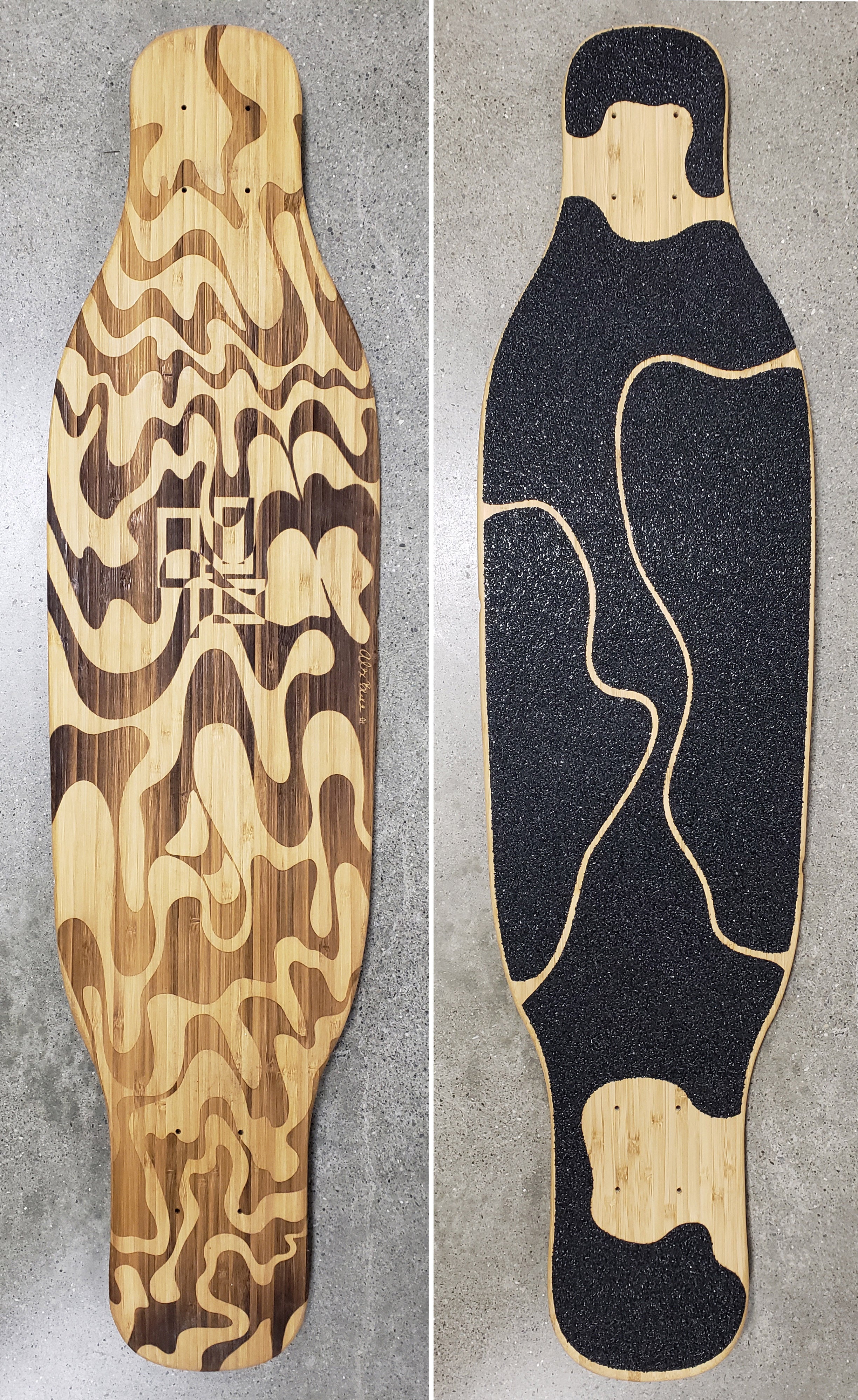 Wood Longboard with a wavy design burned onto the back