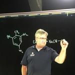Man drawing molecules on the light board