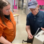 John Sullivan, a retired engineering technician, examines a broken ice cream machine brought to a Fix-It CLE event by CWRU employee Jennifer Bartlett.