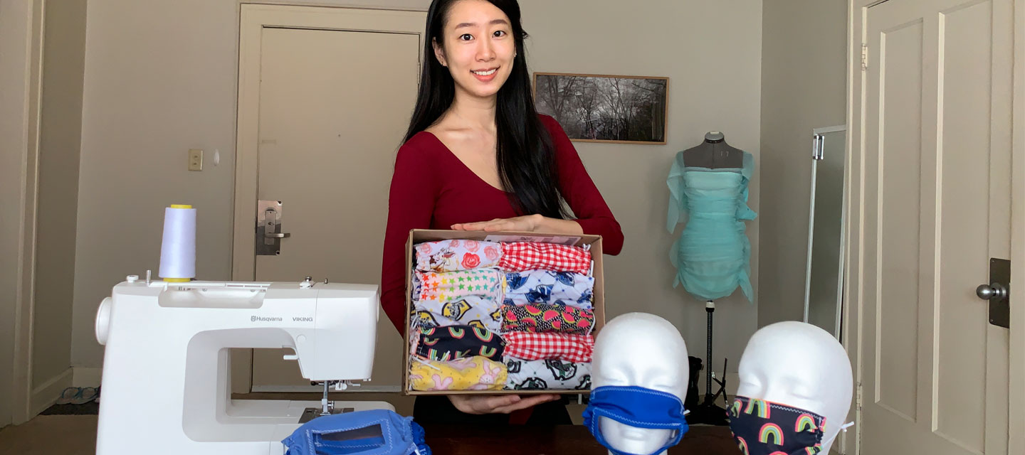 Case Western Reserve student Clare Shin stands near a sewing machine with homemade masks