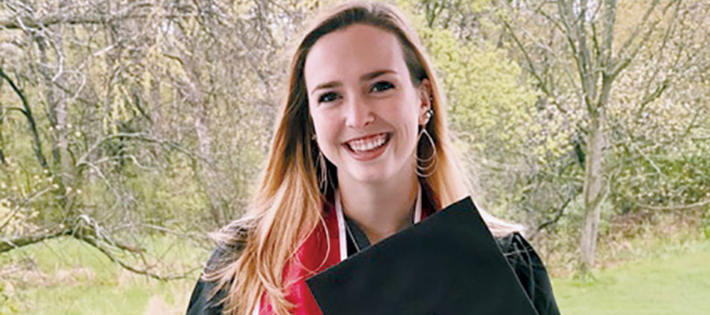 Case Western Reserve University 2020 alumna Grace Moran holding a graduation cap at her home