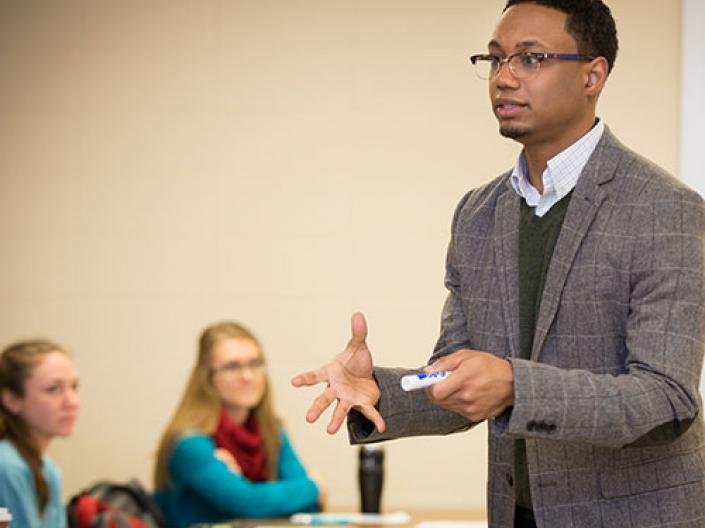 Teacher talking to students in a classroom