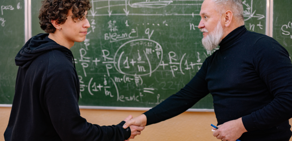 Student and professor shaking hands