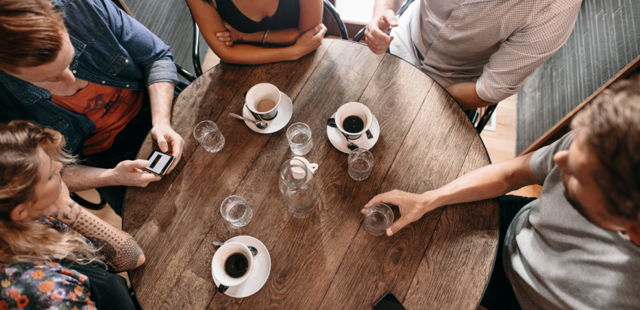 People drinking coffee around a table