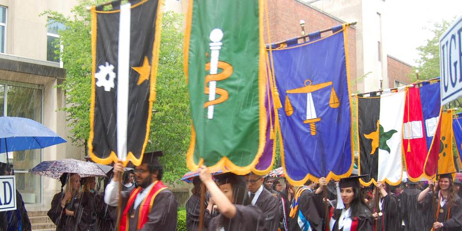 Case Western Reserve University Commencement 2016 graduating students walking with banners