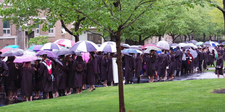 Case Western Reserve University Commencement 2016 graduating students stand outside with umbrellas