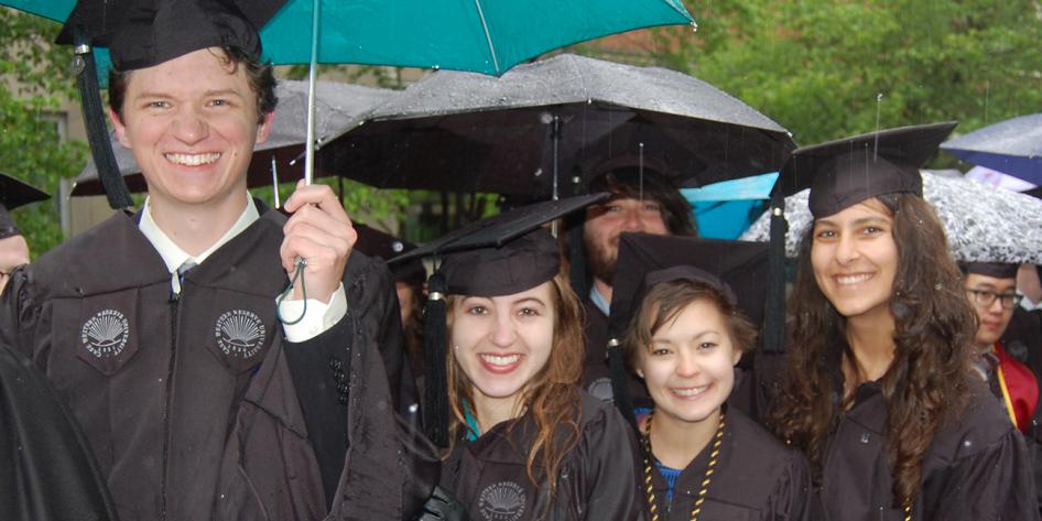 Case Western Reserve University Commencement 2016 small group of graduating students with blue and black umbrellas