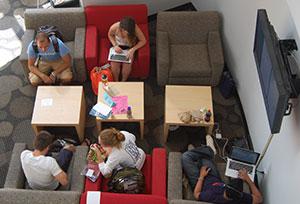 students sitting around square tables
