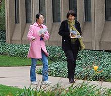 two women walking on campus