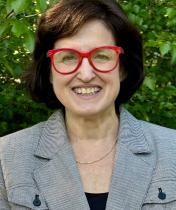 Headshot of Lisa Danielpour wearing red glasses.