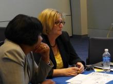 Two woment at a conference table