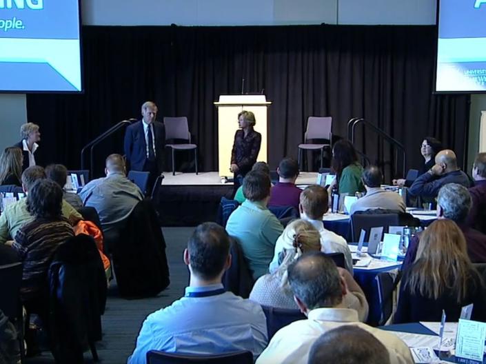 Staff conference with 2 speakers and a seated audience