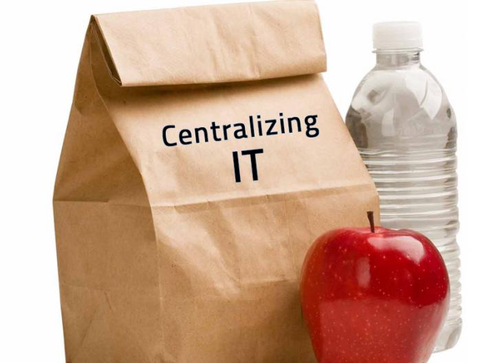 Brown Lunch Bag with the words "Centralizing IT" printed on it with a water bottle and apple next to it