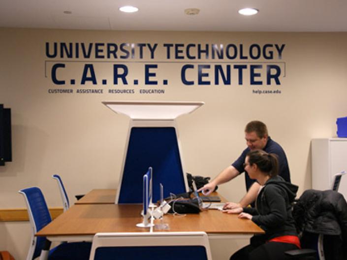 Student being assisted with technology in the C.A.R.E. Center