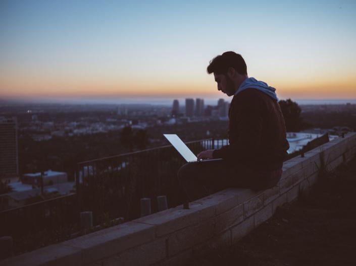 guy on roof on laptop