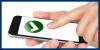 hand holding a smart phone with a green and white check mark on the screen