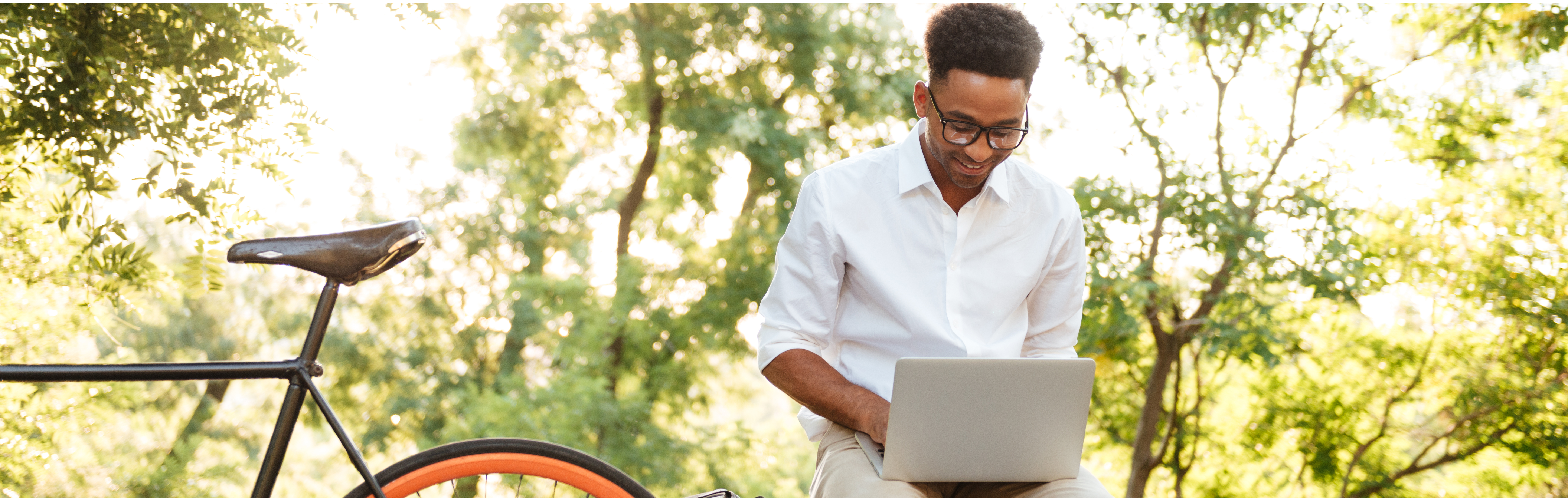 A man is working on his computer outside. 