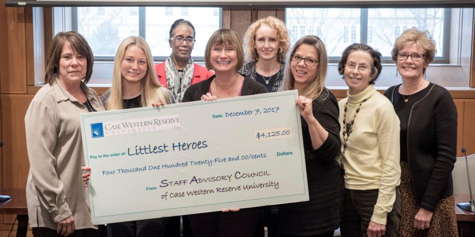 Women holding a large check