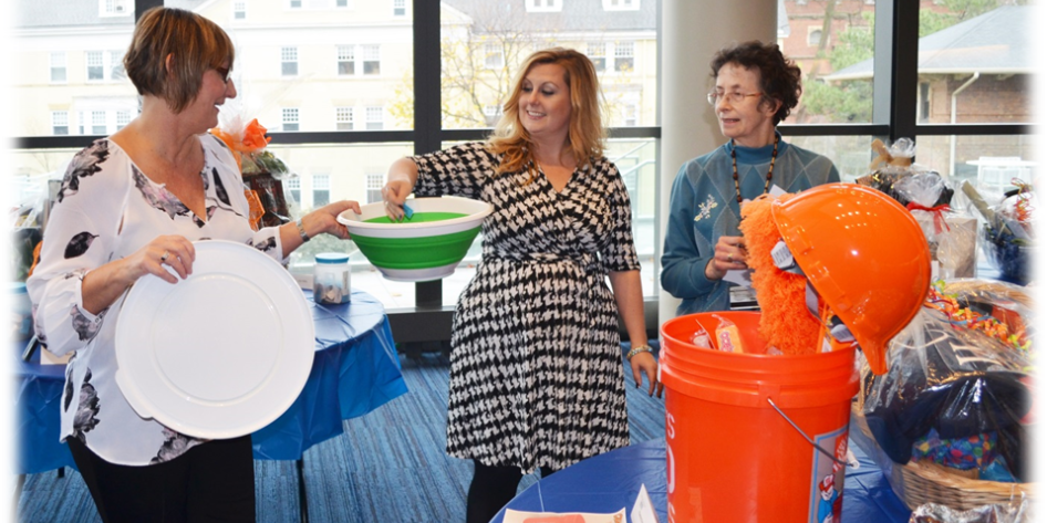 Three women holding objects and talking