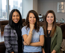 3 women posing, smiling towards the camera